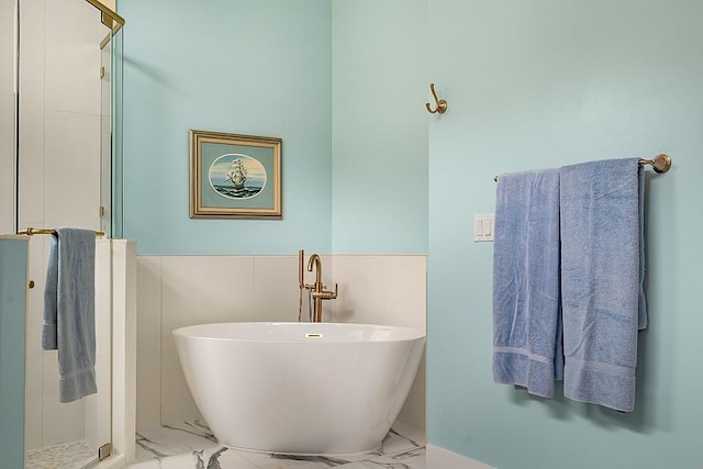 4336 Summer Breeze Ter, Vero Beach, FL 32967 - bathroom with marble look tiles, a shower stall, and a freestanding bath