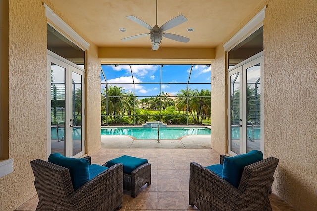 sunroom / solarium with ceiling fan and a pool