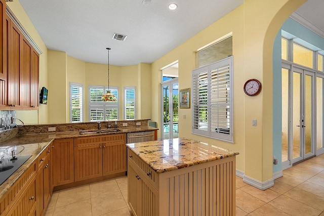 kitchen featuring french doors, a center island, dishwasher, sink, and pendant lighting