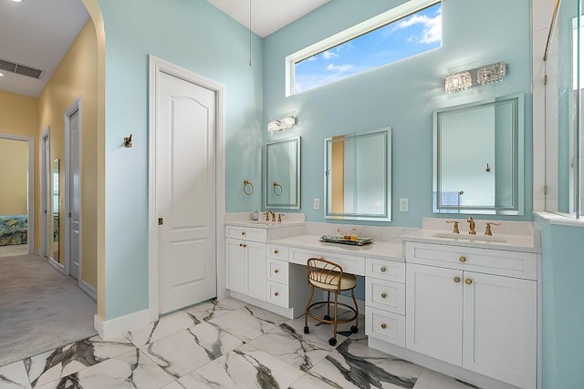 4336 Summer Breeze Ter, Vero Beach, FL 32967 - full bathroom with marble look tiles, double vanity, a towering ceiling, and baseboards