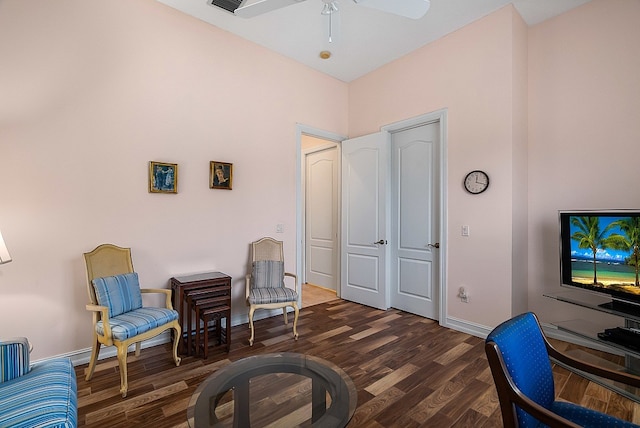 sitting room with a ceiling fan, visible vents, wood finished floors, and baseboards