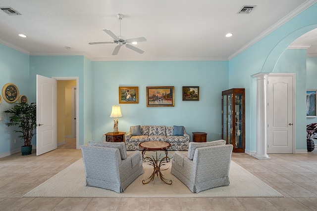 tiled living room featuring ceiling fan, ornate columns, and ornamental molding