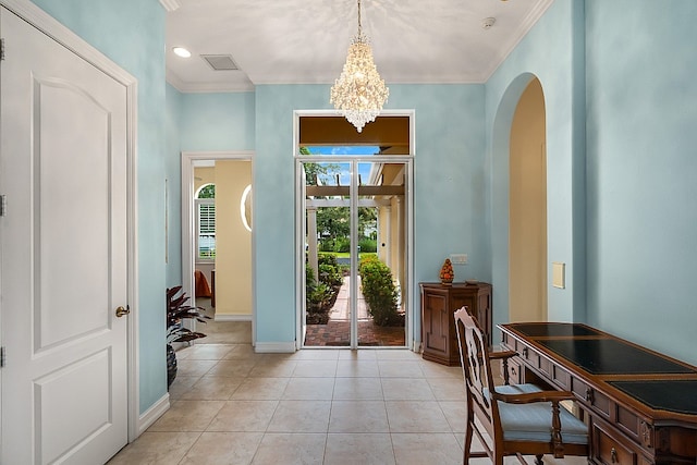 foyer entrance with baseboards, light tile patterned flooring, arched walkways, ornamental molding, and a notable chandelier