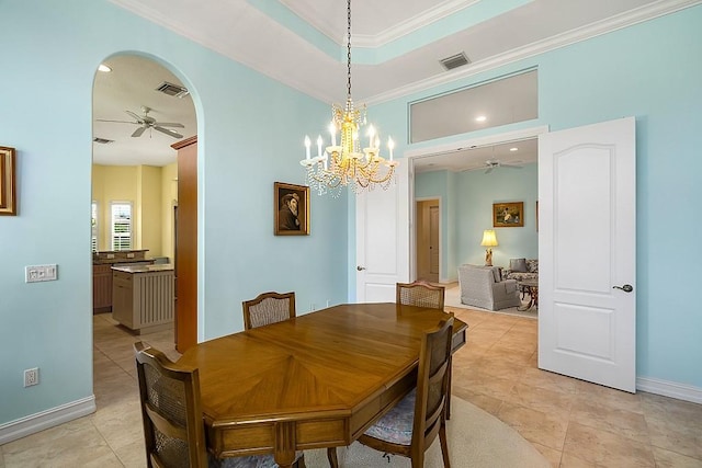 4336 Summer Breeze Ter, Vero Beach, FL 32967 - dining area featuring a ceiling fan, arched walkways, light tile patterned flooring, ornamental molding, and baseboards