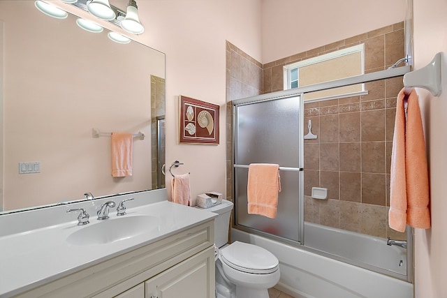 full bathroom with bath / shower combo with glass door, vanity, and toilet