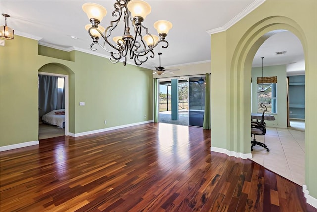 6029 Winfield Dr, Port St Lucie, FL 34986 - unfurnished dining area featuring a healthy amount of sunlight, arched walkways, crown molding, and visible vents