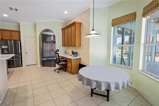 6029 Winfield Dr, Port St Lucie, FL 34986 - kitchen with brown cabinetry, visible vents, stainless steel refrigerator with ice dispenser, light countertops, and light tile patterned floors