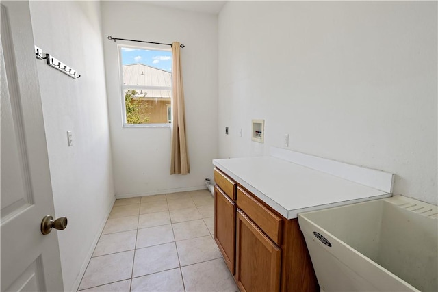 6029 Winfield Dr, Port St Lucie, FL 34986 - laundry area featuring hookup for an electric dryer, cabinet space, a sink, light tile patterned floors, and hookup for a washing machine