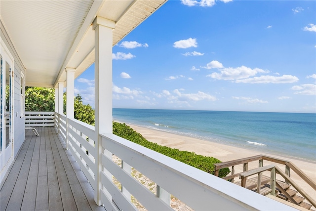 balcony with a beach view and a water view