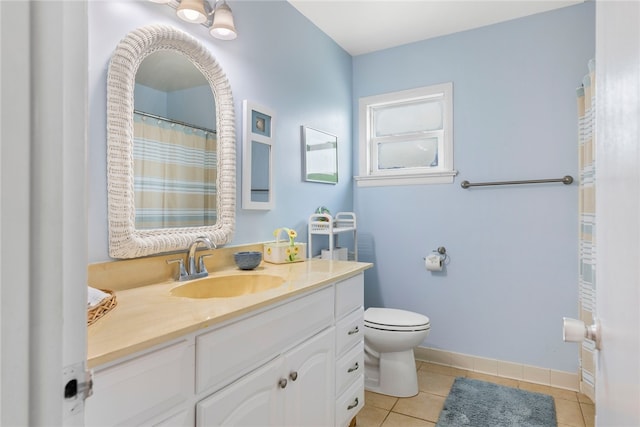 bathroom featuring vanity, tile patterned flooring, and toilet