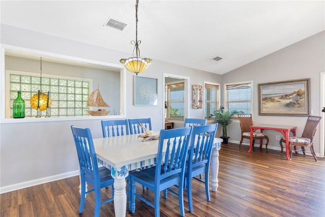 dining space featuring lofted ceiling and dark hardwood / wood-style flooring