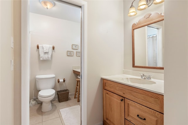 bathroom featuring vanity, tile patterned floors, and toilet