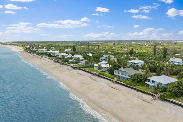 bird's eye view with a water view and a beach view