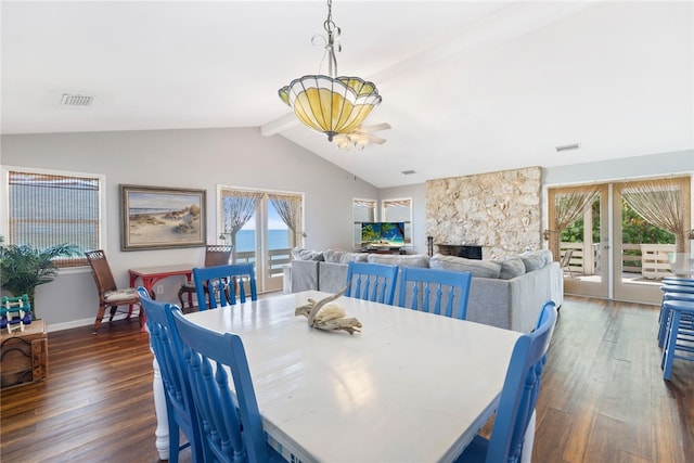 dining area with french doors, a fireplace, dark hardwood / wood-style floors, ceiling fan, and lofted ceiling with beams