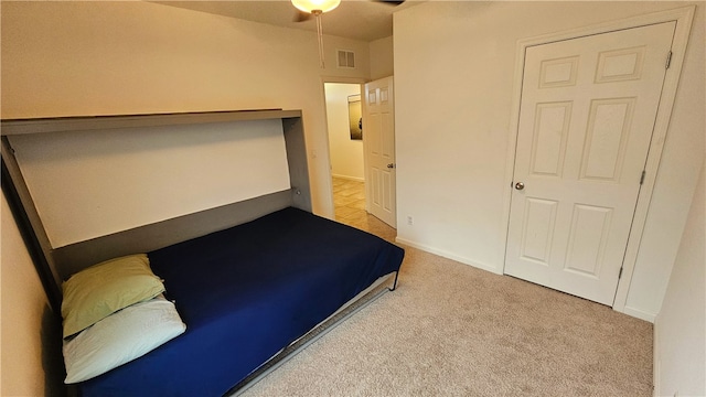 unfurnished bedroom featuring light colored carpet and ceiling fan