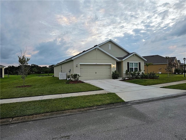 2735 Hanover St SW, Vero Beach, FL 32968 - ranch-style house with a front lawn, an attached garage, driveway, and stucco siding