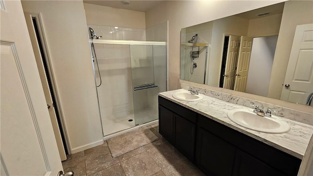 2735 Hanover St SW, Vero Beach, FL 32968 - bathroom with a shower stall, double vanity, stone finish floors, and baseboards