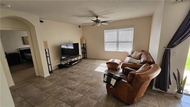 2735 Hanover St SW, Vero Beach, FL 32968 - living area with a ceiling fan, a textured ceiling, baseboards, and arched walkways