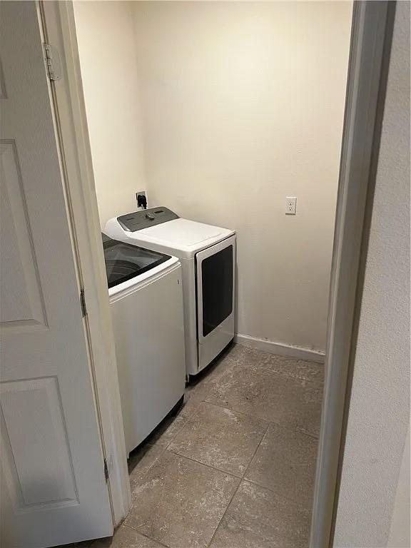 2735 Hanover St SW, Vero Beach, FL 32968 - washroom featuring washing machine and dryer and baseboards