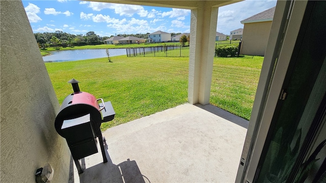 view of yard featuring a patio and a water view