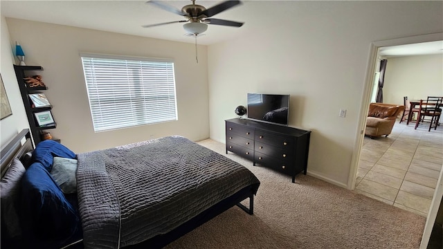 bedroom with ceiling fan and light tile patterned floors