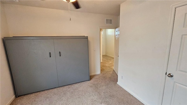 2735 Hanover St SW, Vero Beach, FL 32968 - unfurnished bedroom featuring light carpet, baseboards, and a ceiling fan