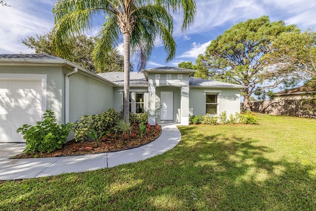 view of front facade with a front yard and a garage