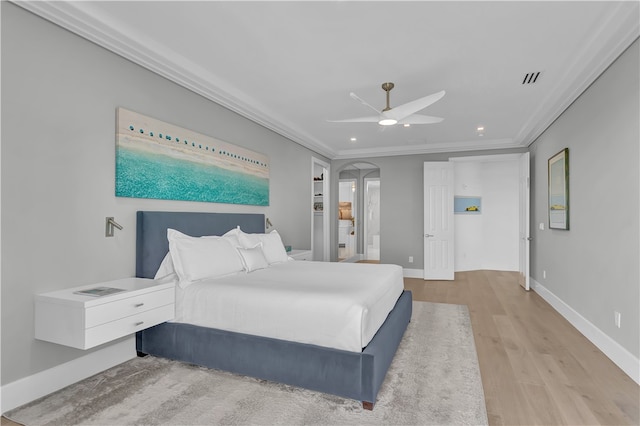 bedroom with crown molding, ceiling fan, and light hardwood / wood-style flooring