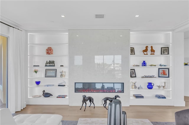 living room featuring built in shelves and light wood-type flooring