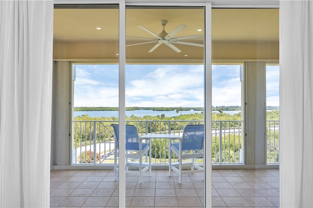 doorway featuring plenty of natural light, a water view, and ceiling fan