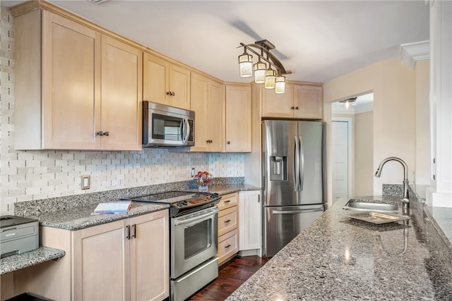 kitchen featuring appliances with stainless steel finishes, dark hardwood / wood-style floors, stone countertops, light brown cabinetry, and sink