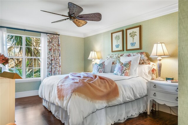 bedroom with ornamental molding, dark wood-type flooring, and ceiling fan