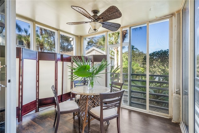 sunroom featuring ceiling fan and plenty of natural light