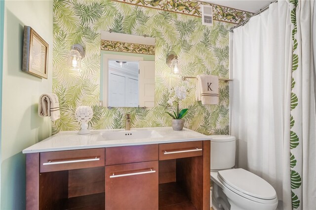 bathroom with vanity and toilet