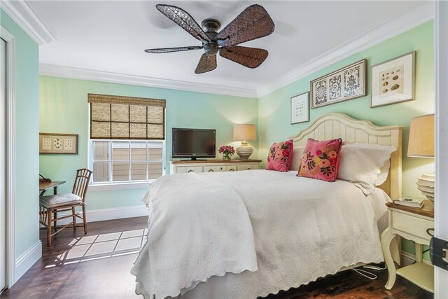 bedroom with ornamental molding, hardwood / wood-style floors, and ceiling fan