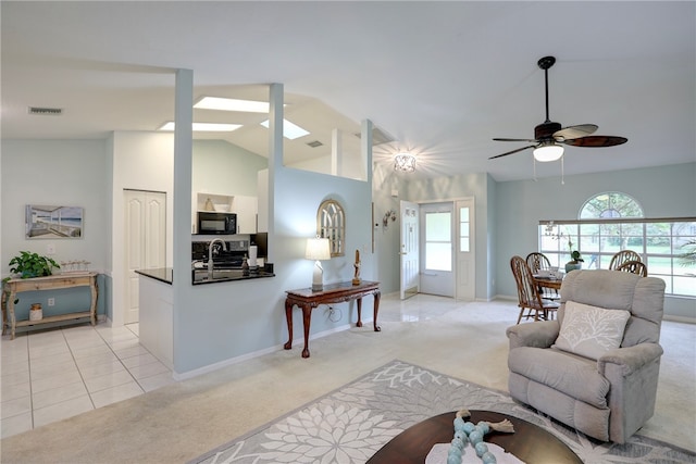 carpeted living room with lofted ceiling and ceiling fan