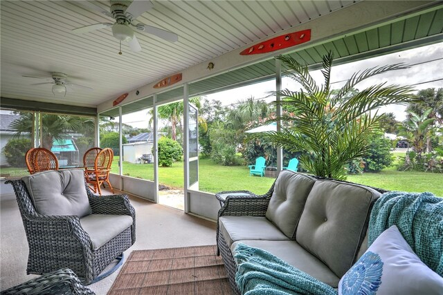 sunroom / solarium featuring a healthy amount of sunlight and ceiling fan