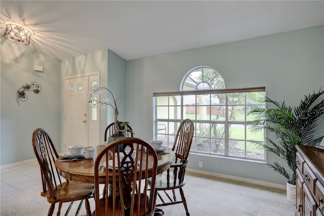 dining space featuring light colored carpet and a healthy amount of sunlight