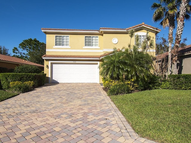 4368 56th Ln, Vero Beach, FL 32967 - mediterranean / spanish-style home with stucco siding, decorative driveway, an attached garage, a tile roof, and a front yard