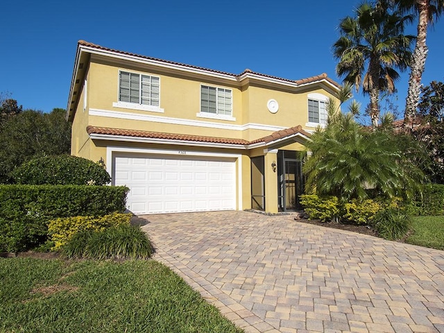 4368 56th Ln, Vero Beach, FL 32967 - view of front facade with stucco siding, a garage, and a tiled roof
