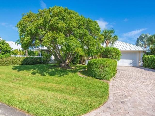 view of property hidden behind natural elements featuring a front lawn