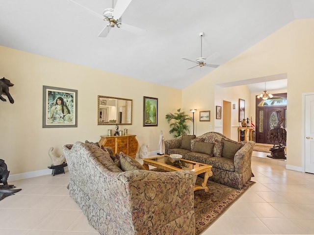 tiled living room featuring ceiling fan with notable chandelier and high vaulted ceiling