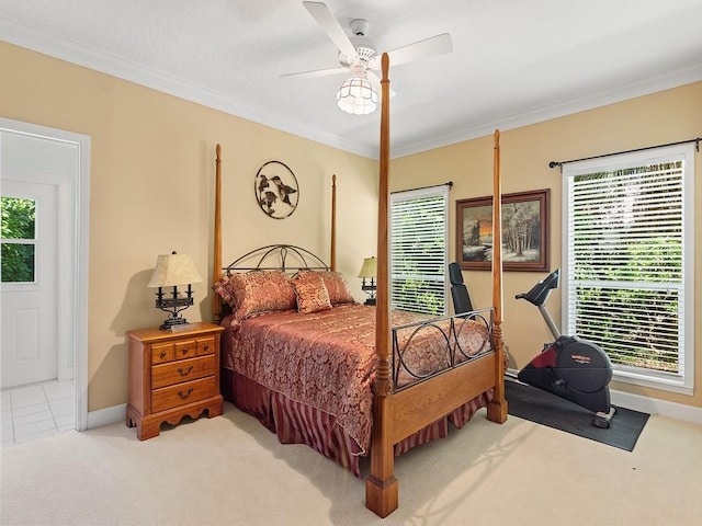 bedroom featuring light carpet, multiple windows, ceiling fan, and ornamental molding