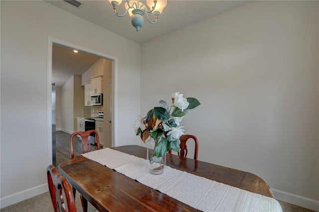 dining room featuring baseboards, a notable chandelier, carpet flooring, and visible vents