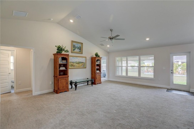 living area with plenty of natural light, a ceiling fan, baseboards, and light colored carpet