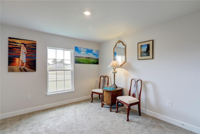 sitting room featuring carpet and baseboards