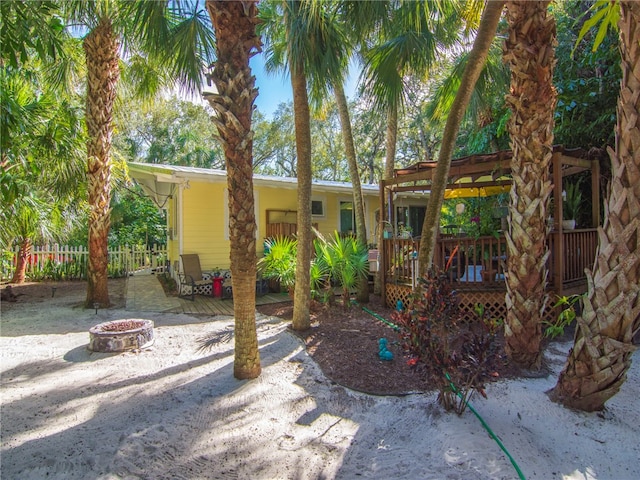 view of yard with an outdoor fire pit and a wooden deck