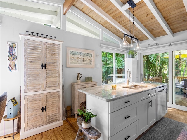 kitchen with light stone countertops, light wood-type flooring, stainless steel dishwasher, sink, and vaulted ceiling with beams