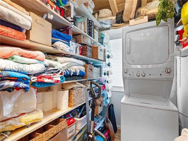 laundry room with stacked washer / dryer