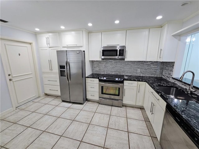 542 9th Pl, Vero Beach, FL 32960 - kitchen featuring stainless steel appliances, tasteful backsplash, white cabinets, ornamental molding, and recessed lighting
